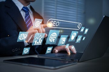 Businessman using computer to analyze SEO, search engine optimization, marketing, traffic ranking,...