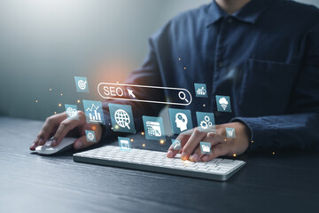 Businessman using computer to analyze SEO, search engine optimization, marketing, traffic ranking,...