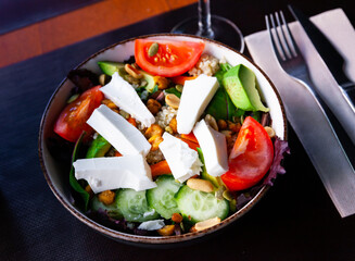 Delicious quinoa salad with tomato, avocado, cucumber, lettuce and fresh cheese