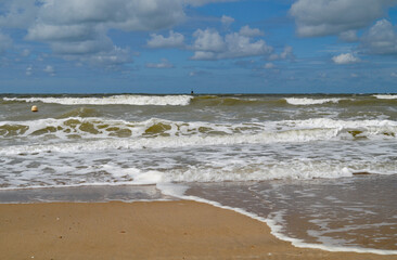 scenic maritime view of the North Sea with its foamy waves and fine-sand beaches of the Belgian city Ostend (Oostende, Belgium)	