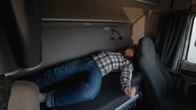 Truck driver waking up in cabin bed during rest