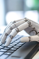 A robot hand typing on a keyboard. Creative concept of robotization, automation of IT processes, artificial intelligence