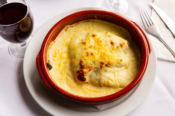 Traditional dish of Italian cuisine is spinach lasagna, made from layers of dough mixed with layers of filling, poured sauce