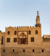 Fototapeta premium Abu Haggag mosque with a detailed entrance and a tall minaret under a clear sky and built inside the Luxor temple