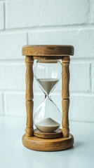 Wooden Hourglass with Flowing Sand on White Background for Time Concept