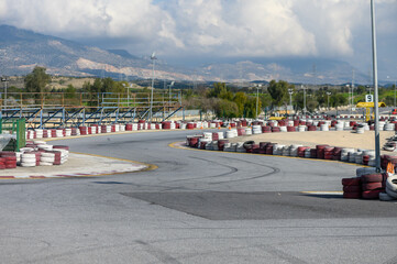 Exciting kart racing track curves around breathtaking mountain landscape in sunny afternoon