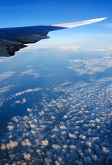 Boeing 747 800 wing and clouds at altitude and in the cruise