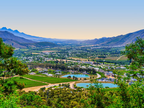 Bird's-eye view of Franschhoek town nestled among trees, showcasing its charm, Franschhoek, South Africa