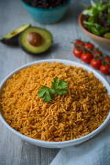 Tasty Jollof and Biryani rice dishes with herbs and spices display. Perfect for culinary guides, cultural food blogs, and cookbooks. High-resolution image capturing vibrant textures and colors.