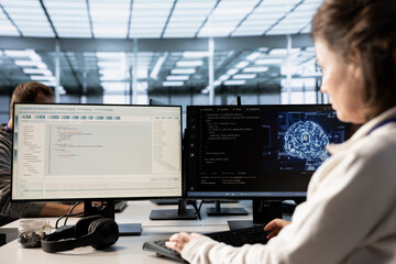 Woman using artificial intelligence technology to optimize data center performance. IT professional...