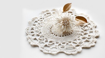 Obraz premium Elegant Crochet Doily with Delicate White Flower and Dried Leaves