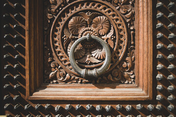 Knock ring on an old wooden carved door