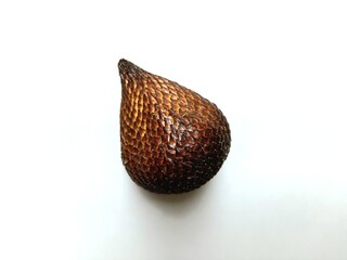 The image shows a single, whole snake fruit isolated against a white background. The fruit is brown with a scaly texture and has a distinctive teardrop shape.