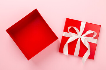 Open red gift box on color background, top view