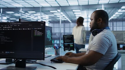 Portrait of joyful technician working in high tech workplace providing computing resources for different workloads. Radiant IT specialist tasked with monitoring data center mainframes, camera B
