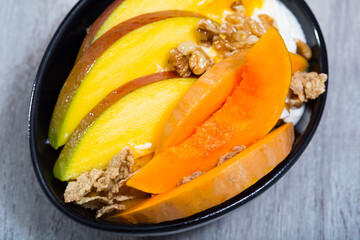 Breakfast with pumpkin and mango. Pumpkin slices bake in the oven, cut mango. Oat flakes, whipped...