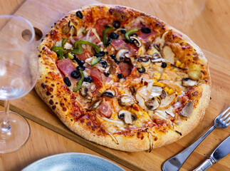Delicious double pizza with different sets of ingredients on pizza slices