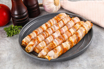 Raw sausages wrapped in bacon