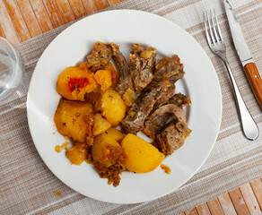 Spicy braised rabbit served with stewed potato for dinner