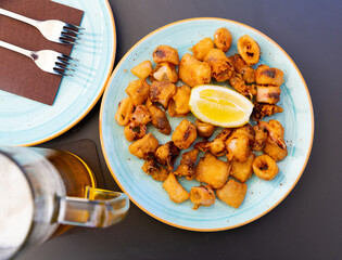 Spanish seafood dish chipirones, battered squid served with slice of lemon