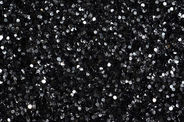 Silver glitter sparkles on a black background, creating a luxurious and festive texture, perfect for holiday decorations, invitations, or any project needing a touch of glamour