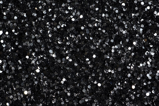Fototapeta Silver glitter sparkles on a black background, creating a luxurious and festive texture, perfect for holiday decorations, invitations, or any project needing a touch of glamour