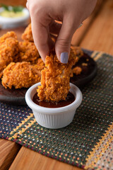 Crispy Fried Chicken wings with French Fries and Beer on a Wooden Board