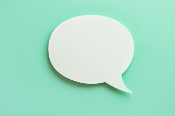 White speech bubble lies on a turquoise background, representing communication and conversation