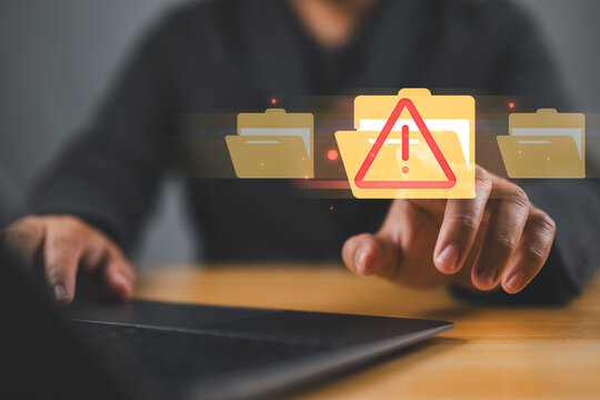 Cybersecurity alert with digital file folder. hand interacting with a cybersecurity alert symbol. virus, spyware, malicious software, malware, or cyberattacks on computer networks. - Powered by Adobe