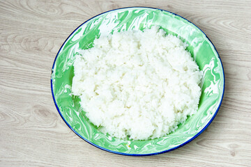 Rice on the green old plate on the table