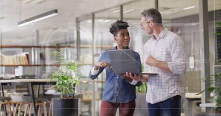 Image of financial data processing over diverse business people in office