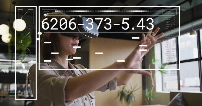 Image of financial data processing over asian businesswoman using vr headset in office