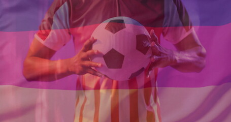 Image of flag of germany over african american male football player with ball