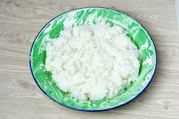 Rice on the green old plate on the table