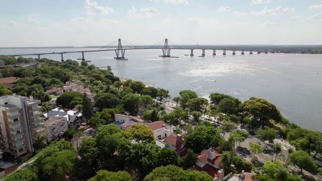 Aerial Drone View of Corrientes Costanera and Bridge on a Sunny Day with People Enjoying the Water