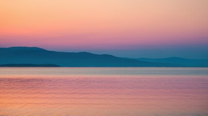 Tranquil sunset over calm waters, showcasing vibrant hues of purple, pink, and orange across the sky and reflected in the serene lake.
