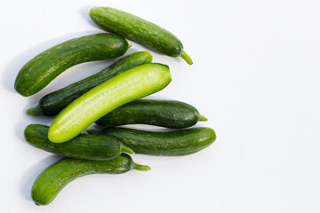 Mini cucumbers on white background.