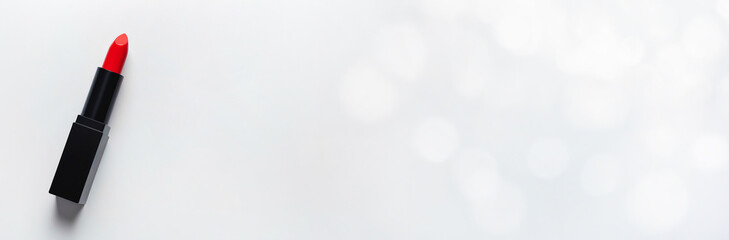 Obraz premium Tube of red lipstick on a white background with space for text. 