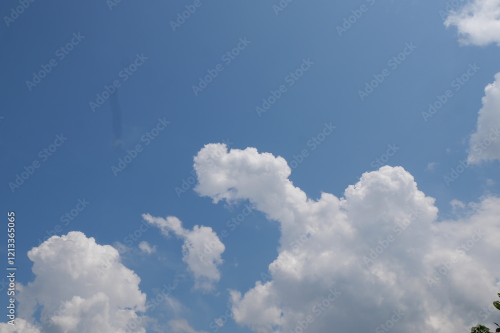 Wall mural Summer blue sky, rainy season, gradient clouds, bright white and blue background. The beauty of bright clouds in the sun, the calm and clear winter air. The gloomy blue-green landscape in the environm