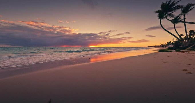 Tropical Island Beach Sunset with Palms and Ocean Waves Distant Horizon View, Bavaro, Punta Cana, Dominican Republic, Caribbean sea