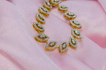 Close up shot o golden leaf design necklace.