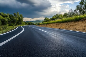 Naklejka premium A long straight road through beautiful fields with trees along the road and wide open horizons.