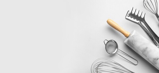 Kitchen utensils on light background with space for text © Pixel-Shot
