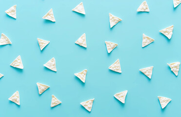 A blue background with white triangles scattered across it