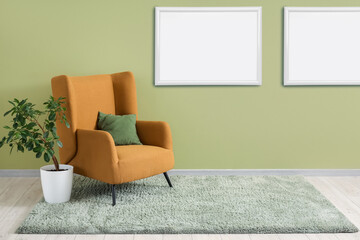 Interior of living room with green carpet, armchair and plant