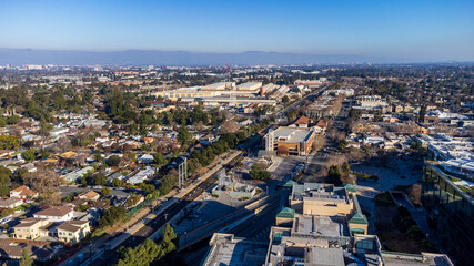 Aerial view of a train station in downtown Sunnyvale surrounded by residential neighborhoods, commercial buildings