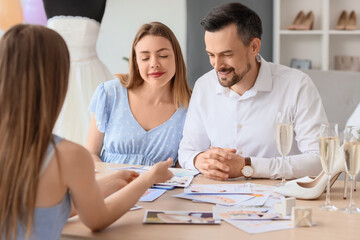 Young couple planning their wedding in office
