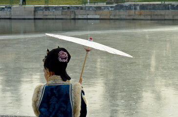 Posing with parasol by the frozen moat of the Forbidden City, Beijing