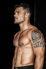 Fototapeta premium Strong muscular man posing with tattoo in an indoor setting during a fitness exhibition
