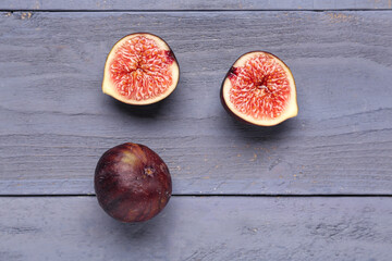 Fresh ripe figs on blue wooden background